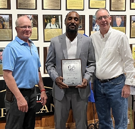 Jerone Boggs proudly accepting RU Amateur Puppy handler of the Year Honors.